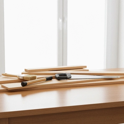 DIY home remodeling tools and materials arranged on a wooden table